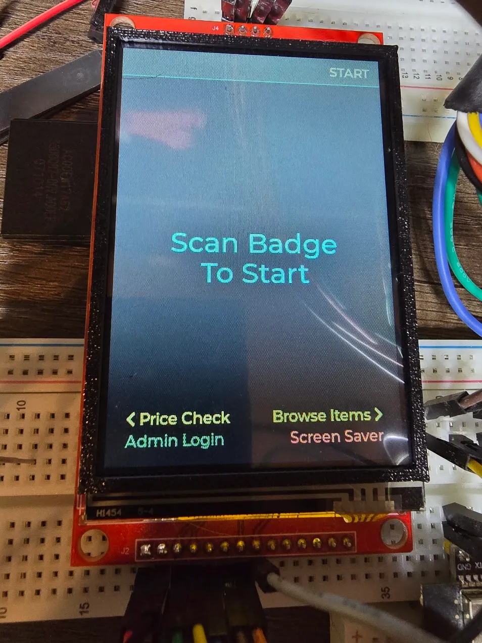 Black printed bezel test-fitted around the bare display showing the start screen