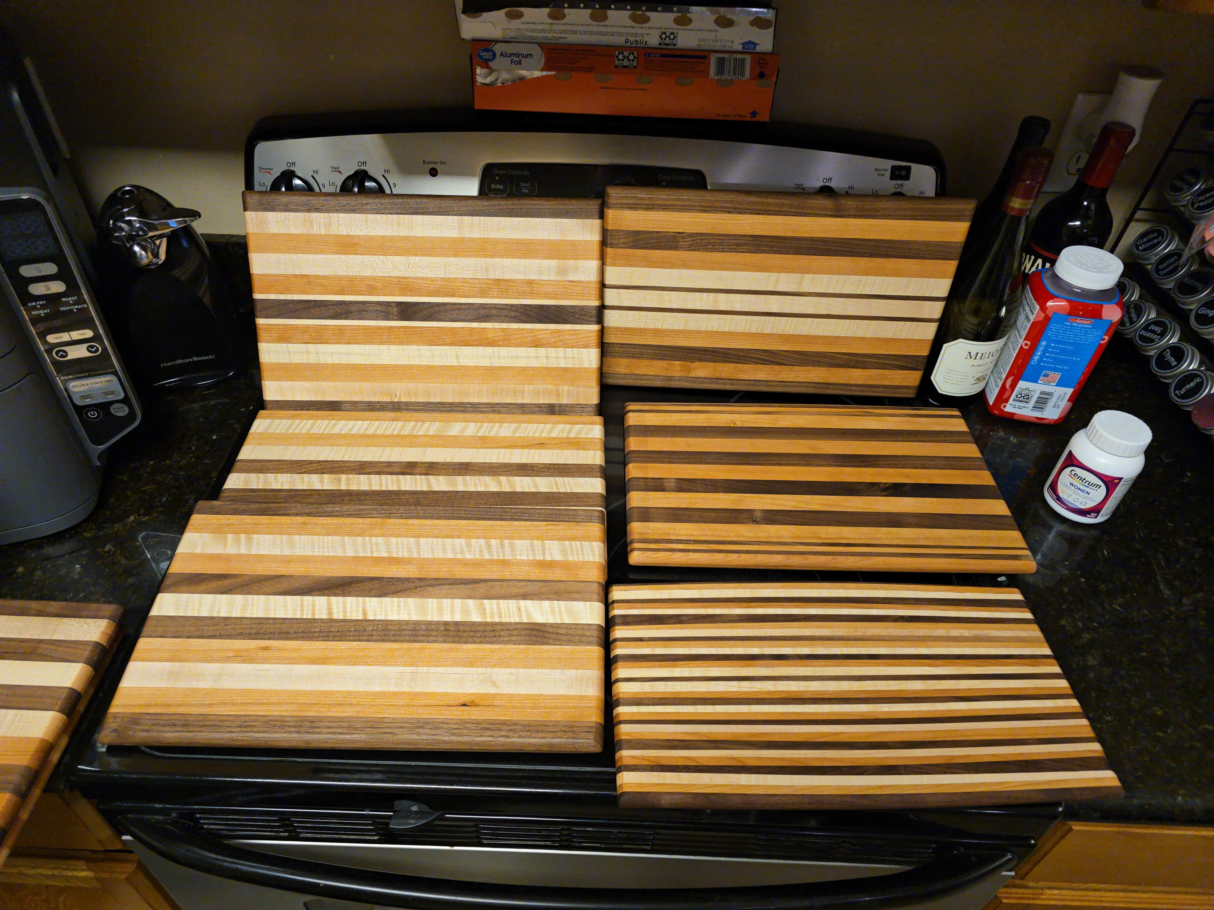 The full batch of finished cutting boards laid out together