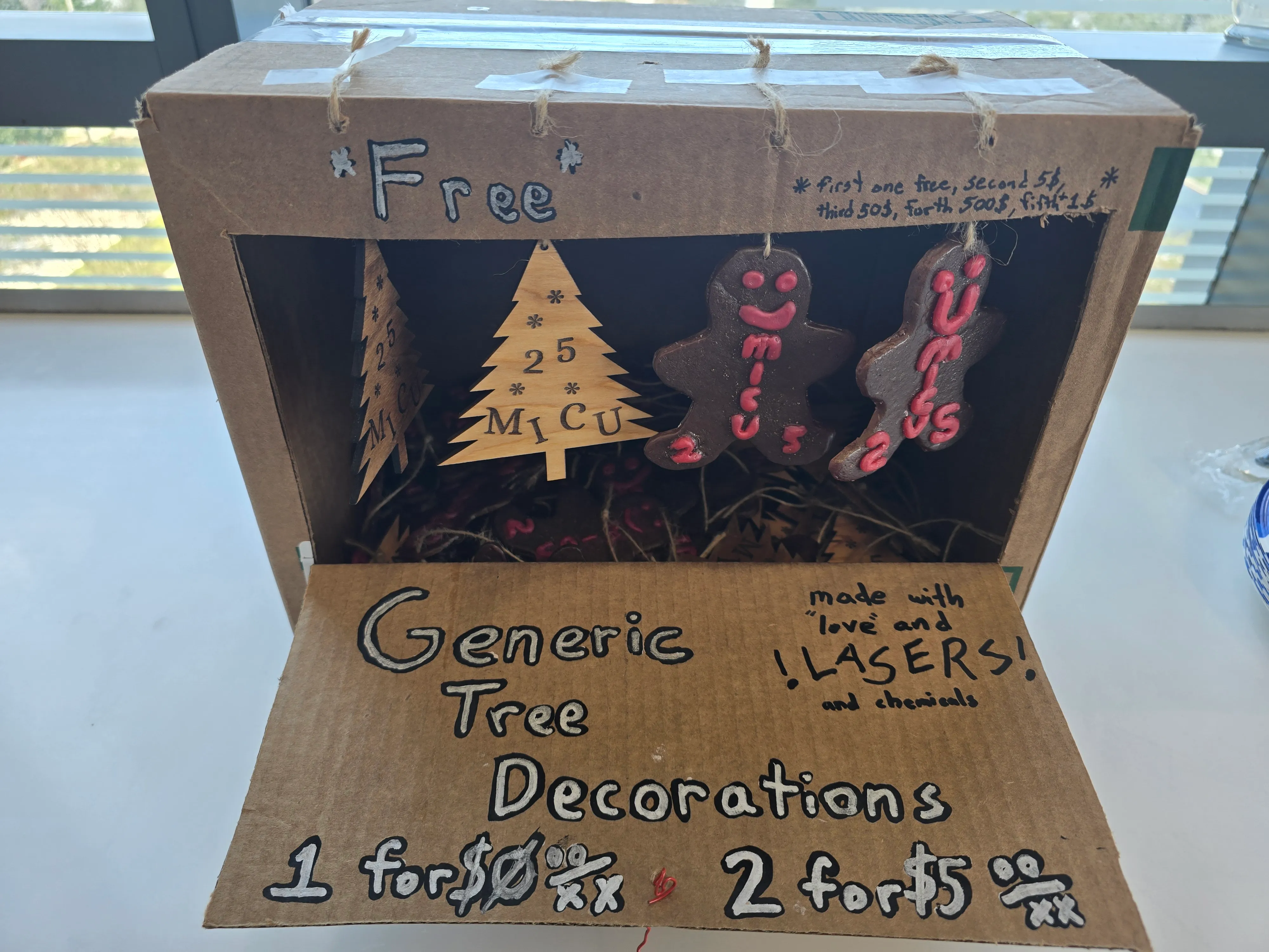 Cardboard gift-shop display box with laser-cut wood trees and epoxy gingerbread ornaments made for MICU staff