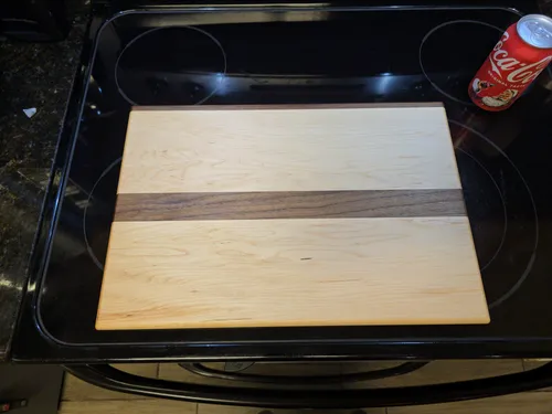 Maple cutting board with an off-center walnut stripe