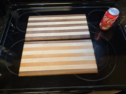 Two finished cutting boards with different wood combinations