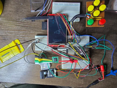 Top-down view of the full breadboard build with display, button array, ESP32-S3, barcode scanner, and RTC breakout all connected
