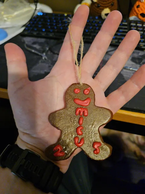Another angle of the finished epoxy gingerbread ornament held in hand