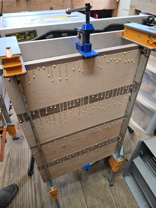 Another striped board blank clamped and curing