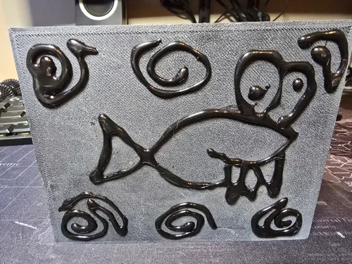 The underside of the enclosure with hot-glue grip lines drawn as the mascot fish surrounded by bubbles