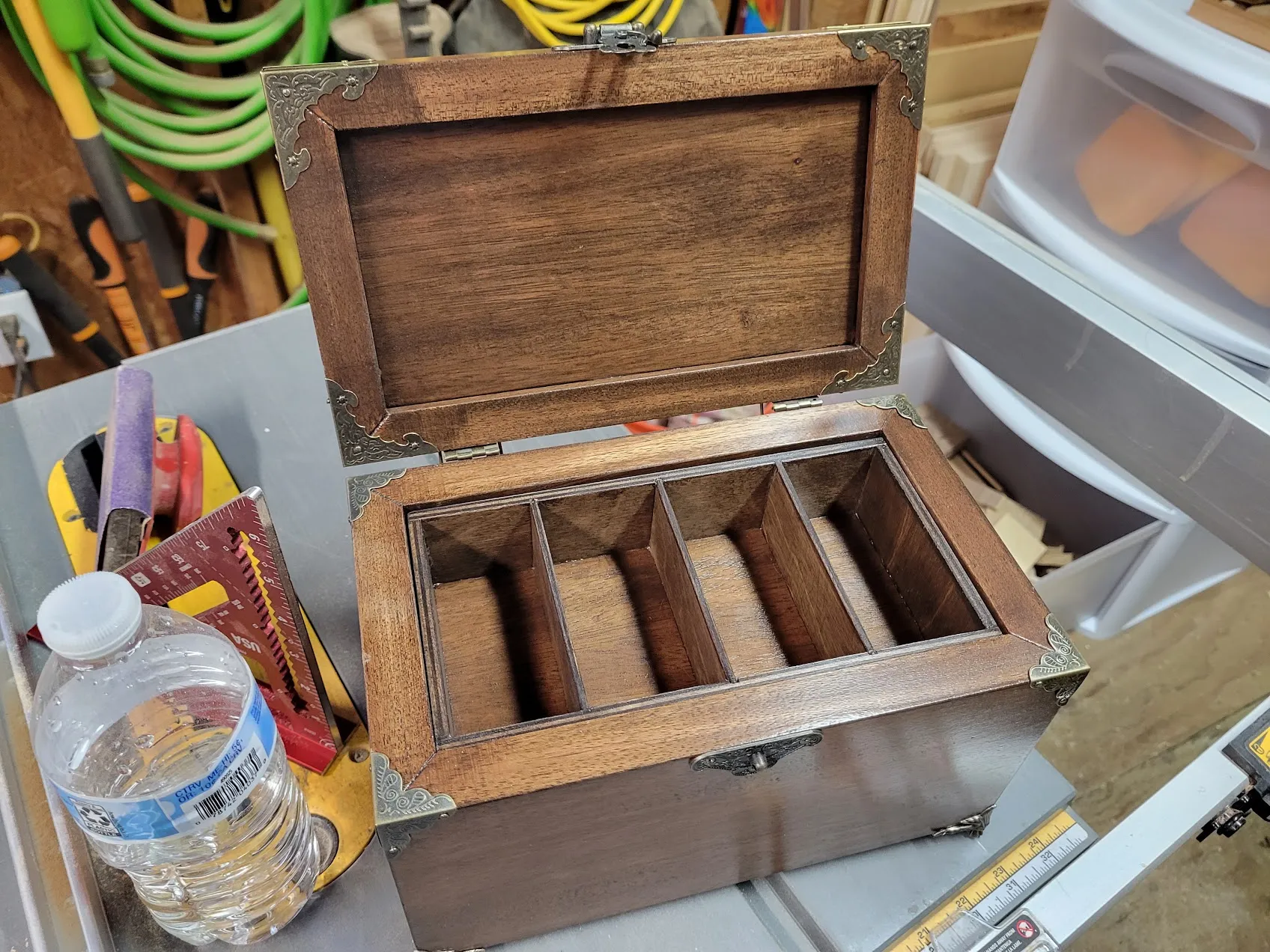 Open mahogany jewelry box with the box-jointed tray still seated inside