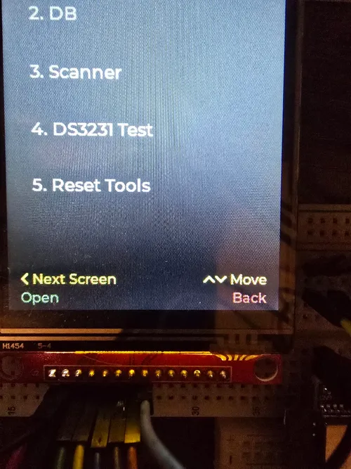 Device menu screen with a green "Open" action label and a red "Back" label in the button legend